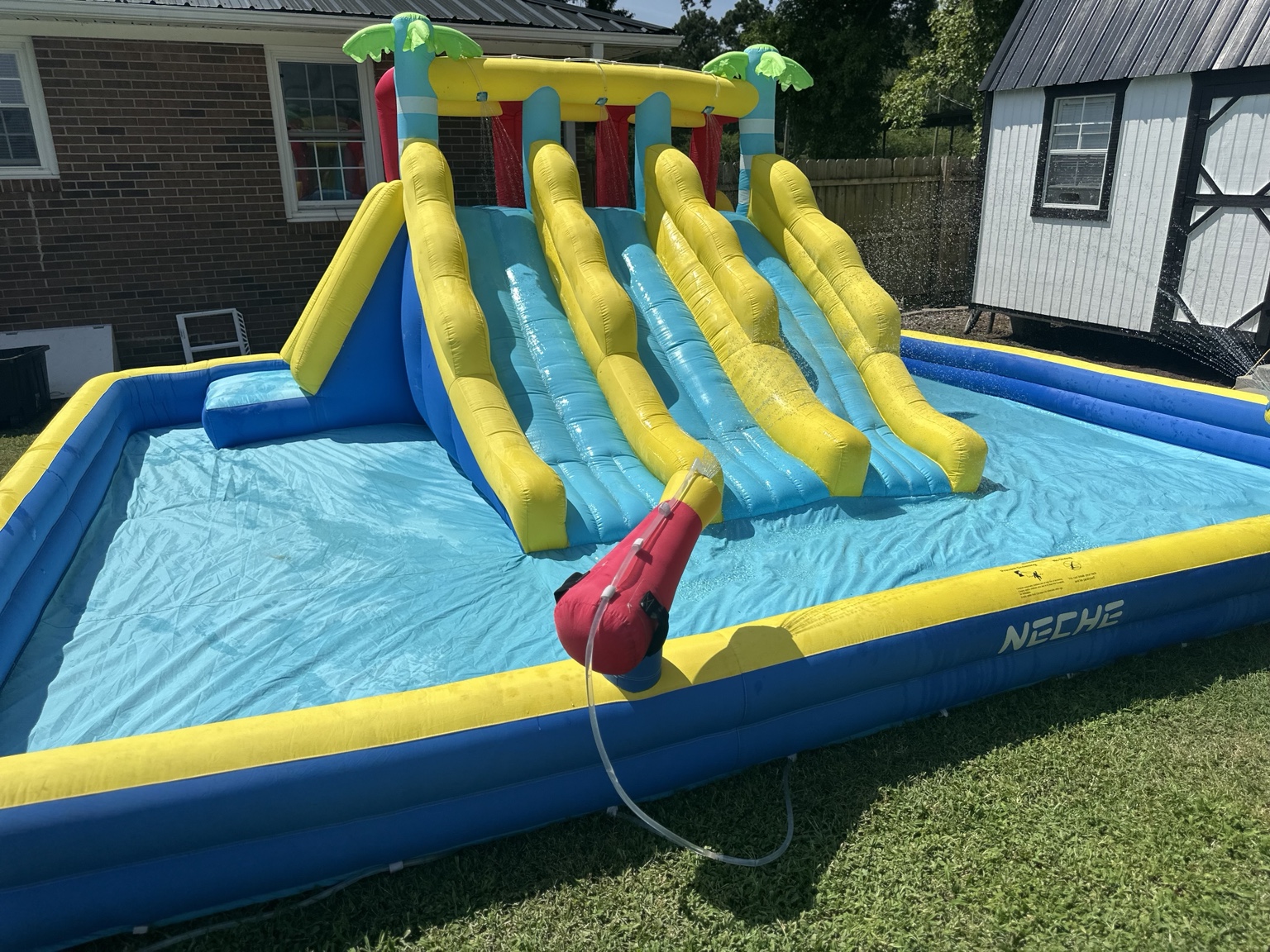 Large blue and yellow multi-lane water slide with splash pool