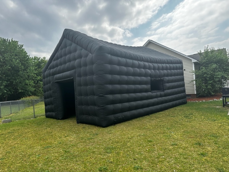 Large black inflatable venue set up on a lawn