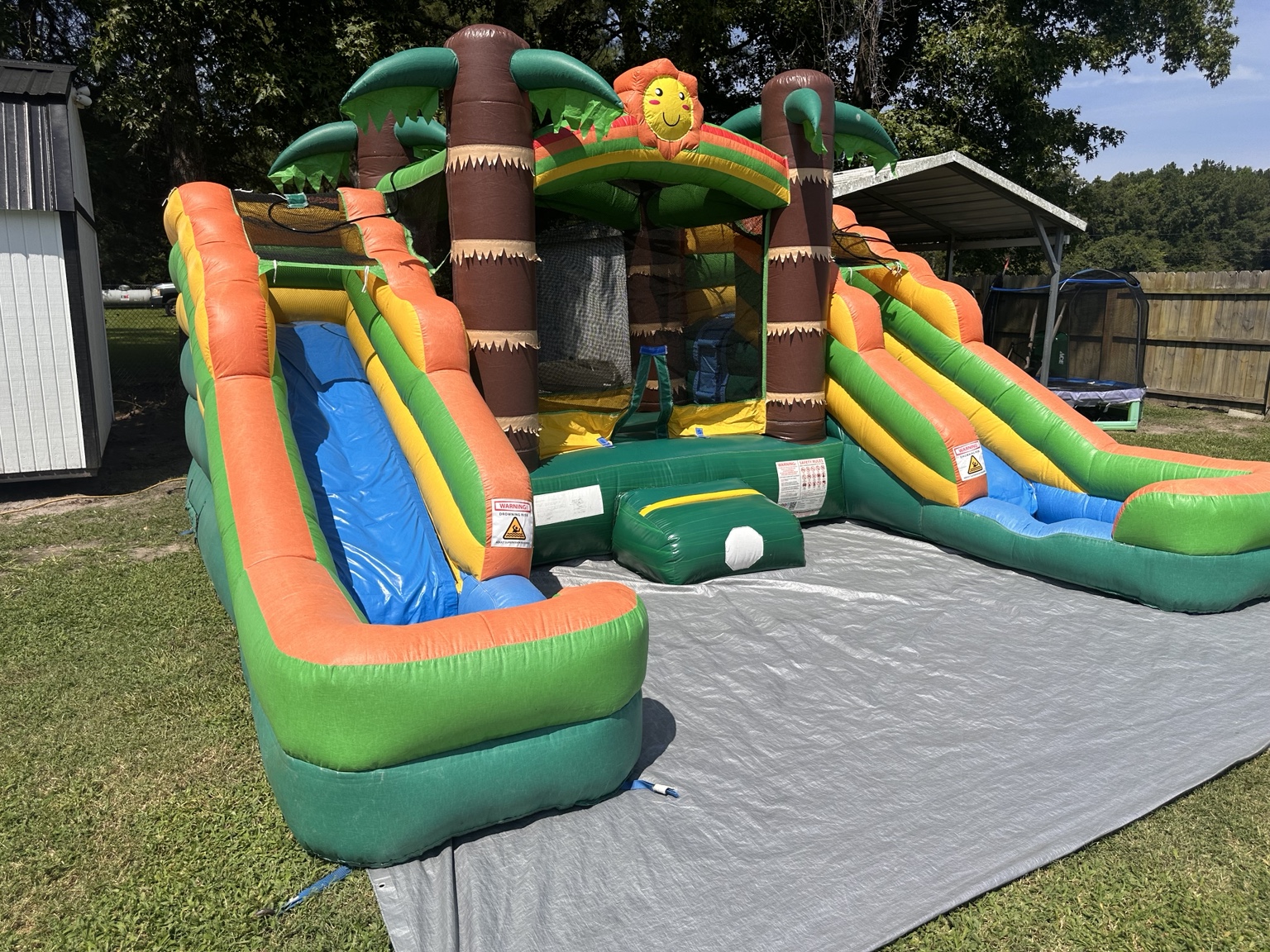 Tropical jungle inflatable combo with two large slides